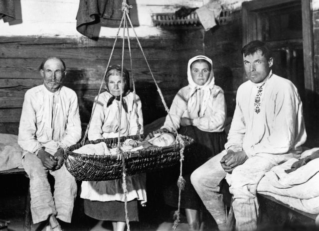 The Winnik family by the cradle; Kosów Poleski district, Polesye Voivodeship, Poland. Photograph by Józef Szymanczyk, 1937. Courtesy of Irena Domanska